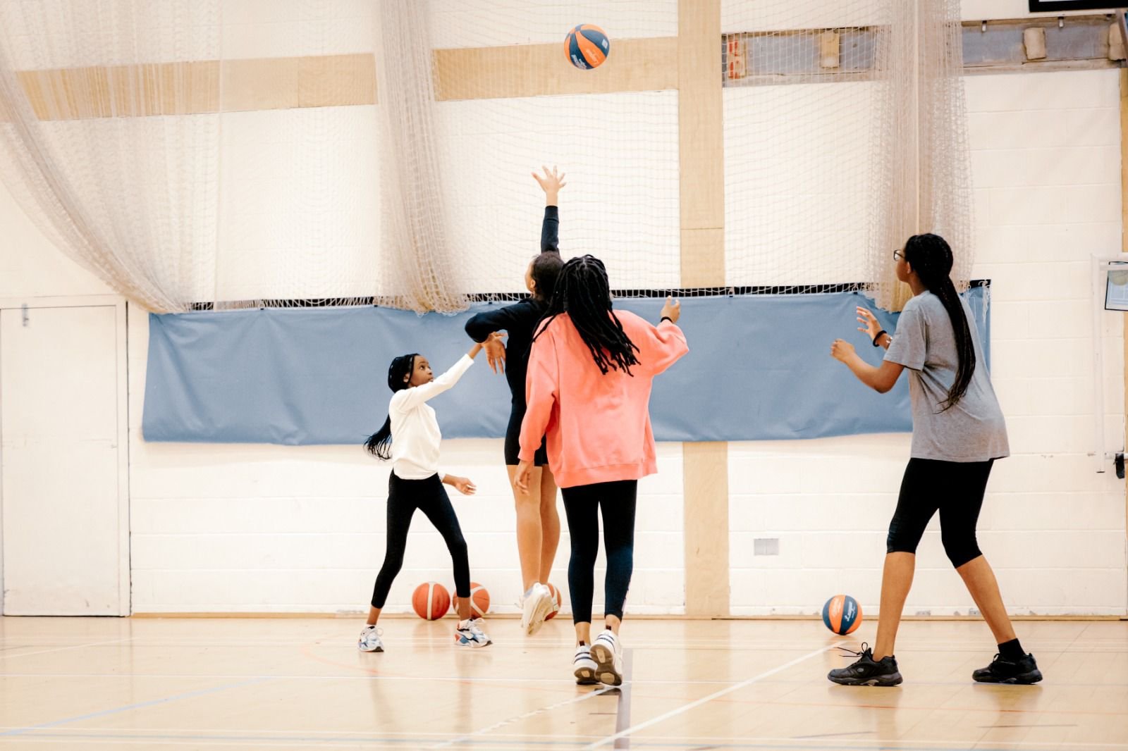 Girls playing a game of basketball