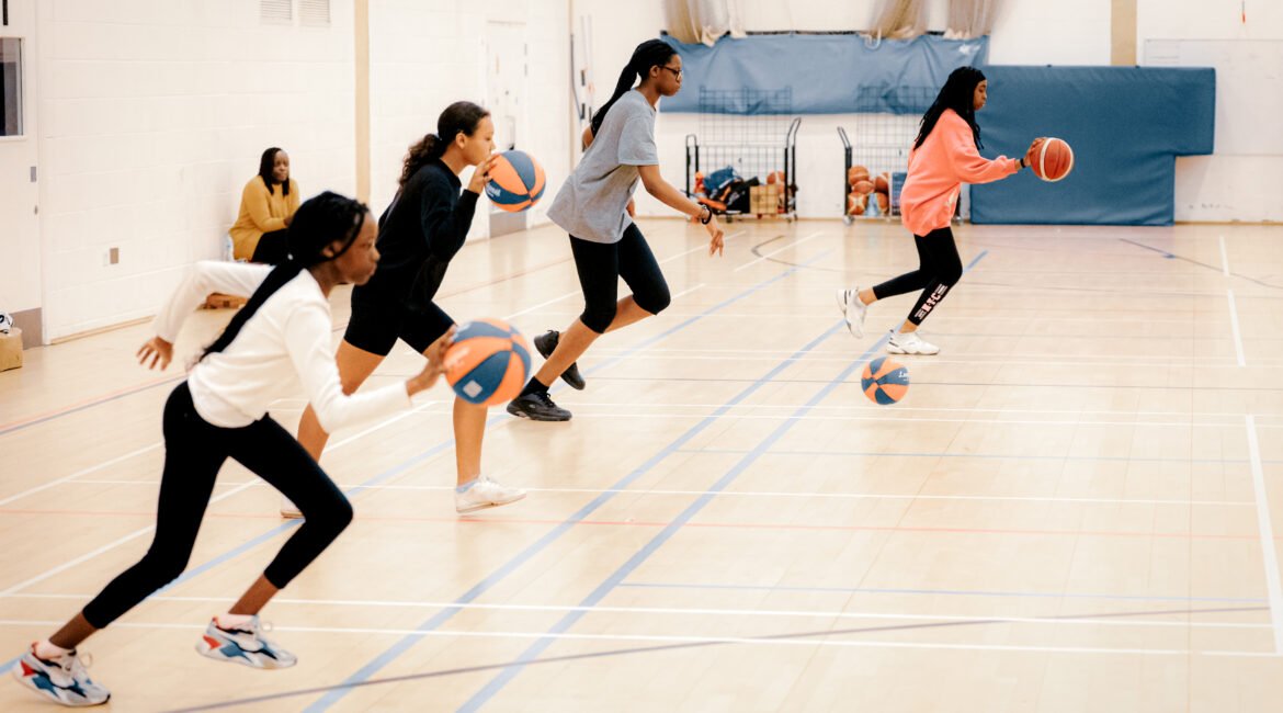 Girls dribbling the basketball