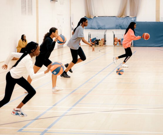 Girls dribbling the basketball